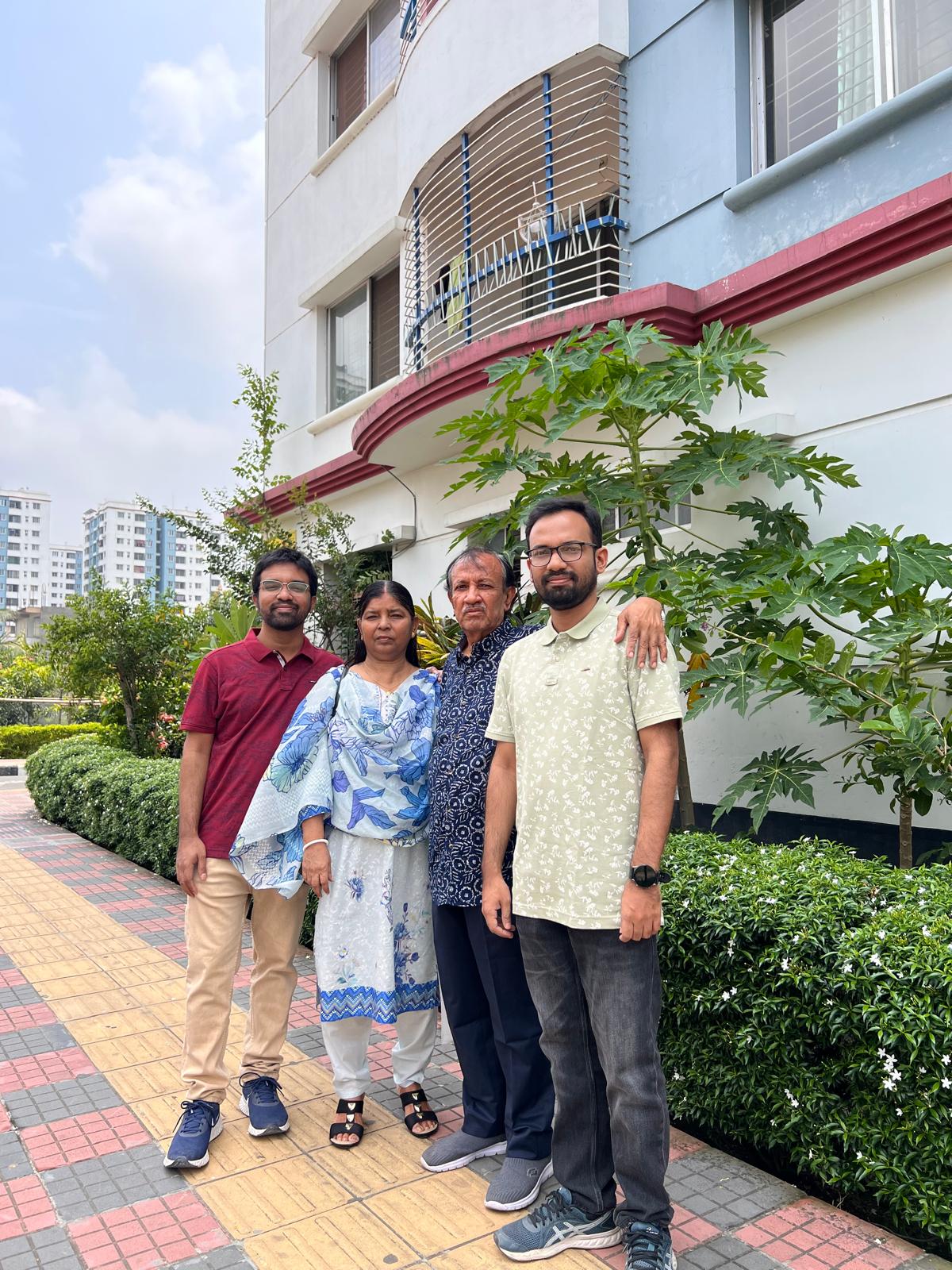 Family portrait outside home in Dhaka