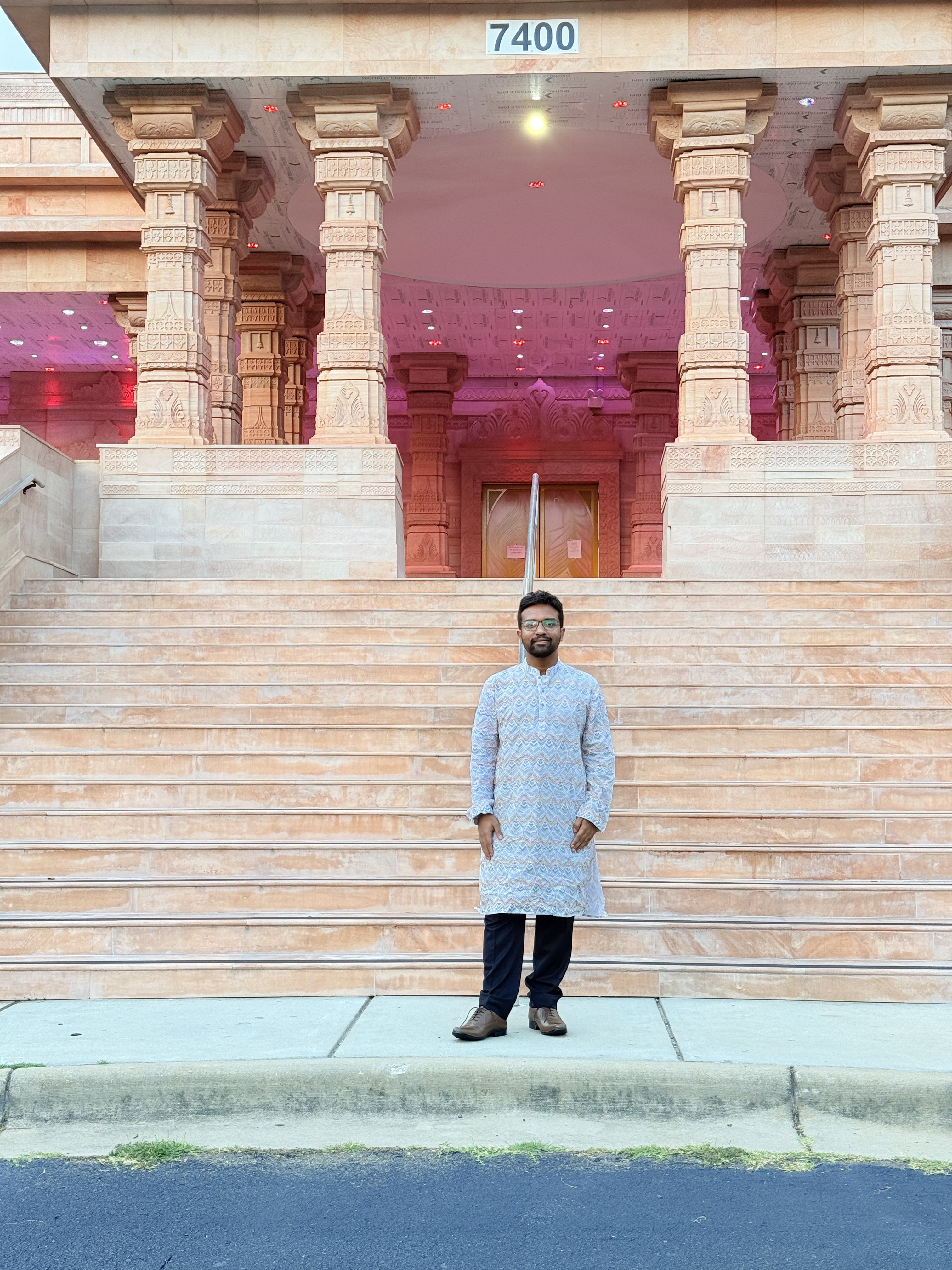 In traditional attire at a carved temple